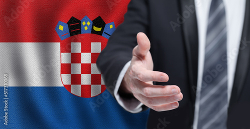 Croatian business, politics, cooperation and travel concept. Hand on flag of Croatia background.