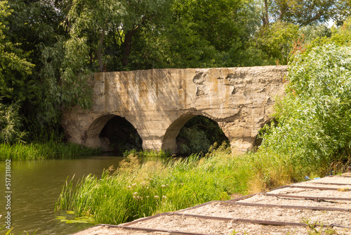 Old abandoned stone bridge across the river in the Lipetsk region