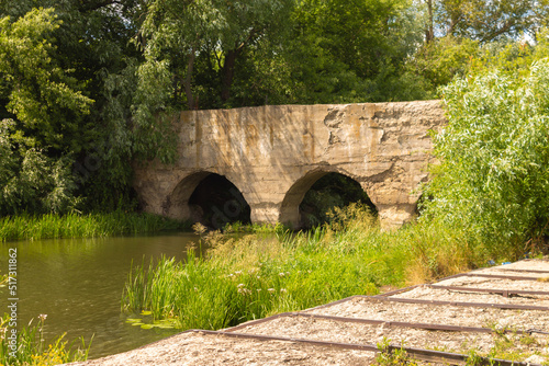 Old abandoned stone bridge across the river in the Lipetsk region