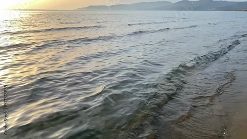 Wallpaper Mural Slow motion of waves crashing on golden beach at sunset. Sea waves splashing on the coastline. Summer vacation and beauty of nature concept Torontodigital.ca