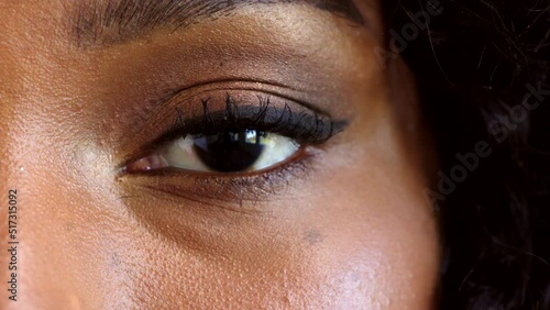 Portrait of a black woman as a victim of racism and gender based violence. Closeup on face and eyes of a female staying woke and radically aware of oppression, discrimination and injustice in society photo