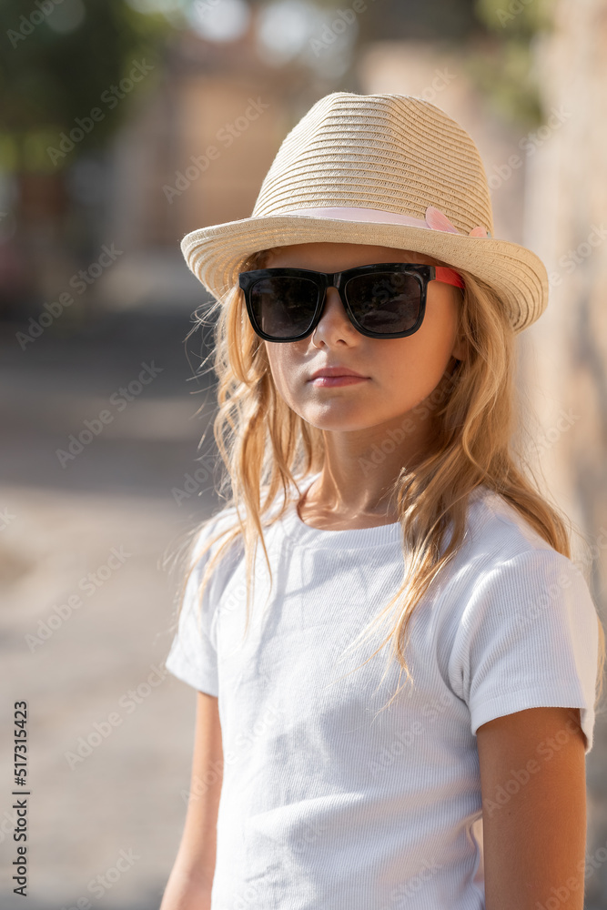 Classic portrait of a kid in a hat and sunglasses.