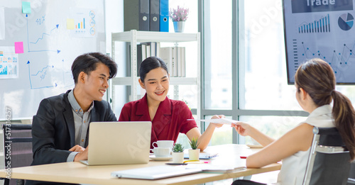Group of millennial Asian multinational multicultural male and female businessman businesswoman teamwork in formal suit sitting smiling brainstorming meeting together in office conference room.