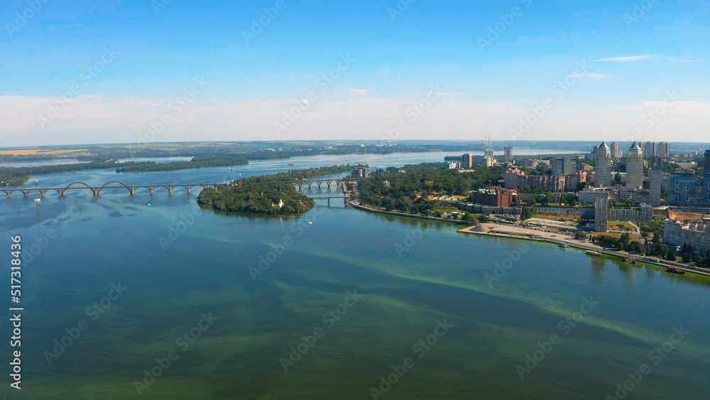 Beautiful summer landscape over the river with view to the downtown. Beautiful  urban environment - drone shooting.  Aerial view on a urban environment Dnepr city.