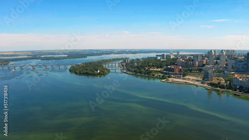 Beautiful summer landscape over the river with view to the downtown. Beautiful  urban environment - drone shooting.  Aerial view on a urban environment Dnepr city.