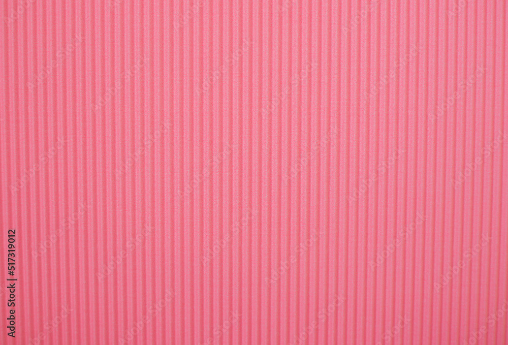 Abstract background made of corrugated paper for pink application. Space for text. Texture. Vertical stripes. Abstract background made of corrugated paper for pink application. Space for text. Texture. Vertical stripes.