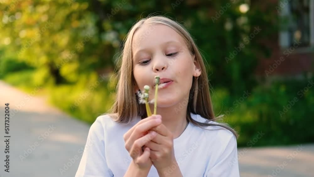 Blonde little girl blowing dandelion and smiling outdoor. Happy child enjoying summer holdidays. Allergy concept Blonde little girl blowing dandelion and smiling outdoor. Happy child enjoying summer holdidays. Allergy concept