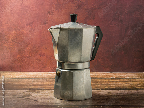 The Moka pot on wood table for hot drink concept photo