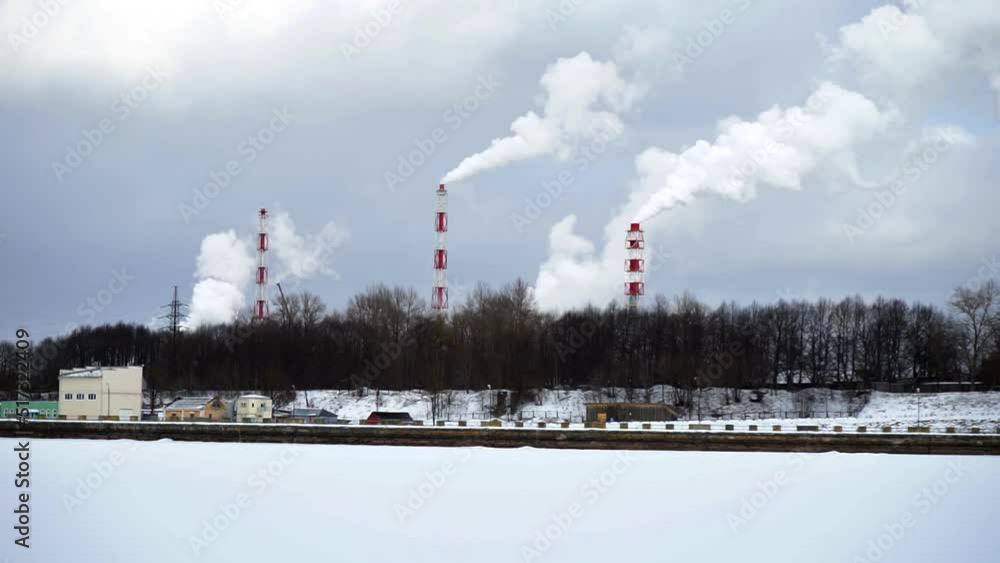 industrial chimneys with heavy smoke causing air pollution on the gray smoky sky background. Smoking pipes of fertilizer plant. Winter industrial landscape industrial chimneys with heavy smoke causing air pollution on the gray smoky sky background. Smoking pipes of fertilizer plant. Winter industrial landscape
