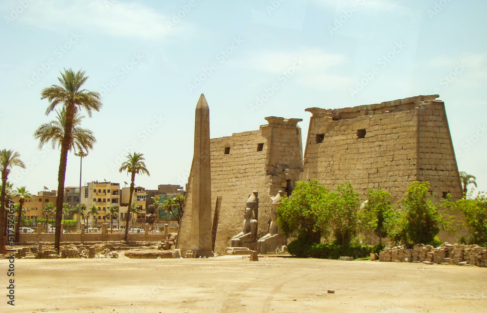 Entrance to the ancient temple of the Pharaohs Karnak, Luxor, Egypt. Statues on the sides and obelisk on center.