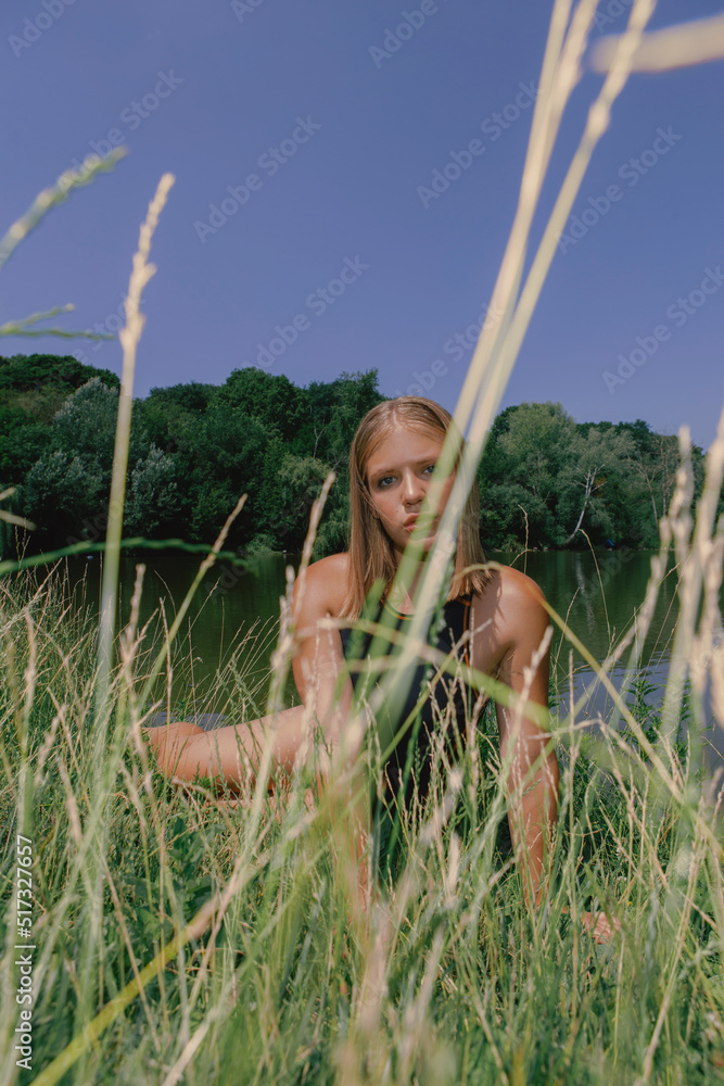 Portrait of a young beautiful woman on a background of flowers, summer flora, spring and nature Portrait of a young beautiful woman on a background of flowers, summer flora, spring and nature