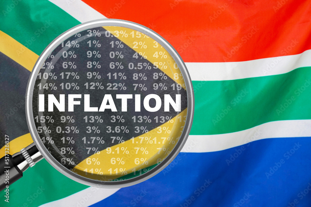 Magnifying glass focused on the word inflation on South Africa flag