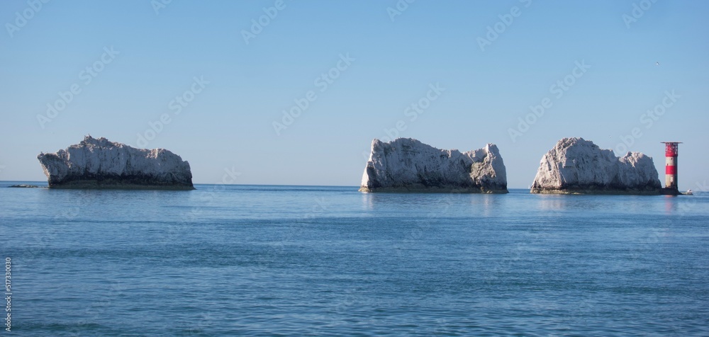 The Needles lighthouse filmed from a yacht on a very calm sunny day plus 2 of the chalk stacks on the Isle of Wight close to Alum Bay and Totland Bay.