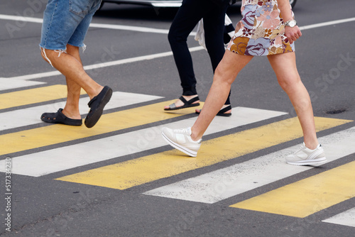 people crossing the road at a pedestrian crossing