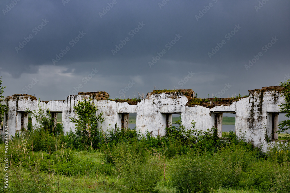 The remains of a white building against a stormy sky. architecture and nature