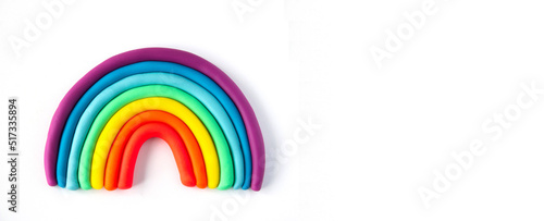 Banner of a colorful rainbow of plasticine on white background. Made from plasticine. Isolate