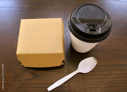 Disposable paper food packaging and plastic cutlery.