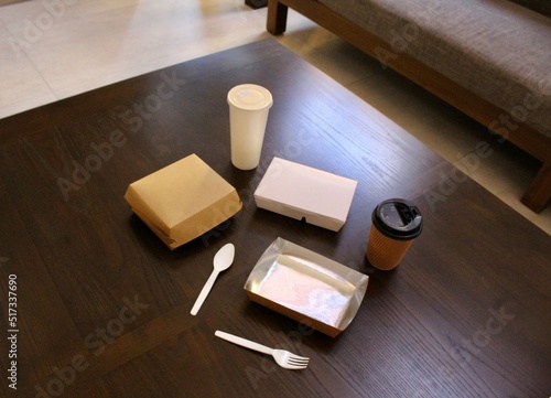Disposable paper food packaging and plastic cutlery.