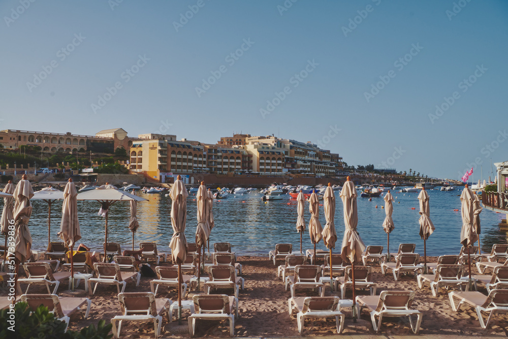 Obraz premium beach sun beds at golden hour