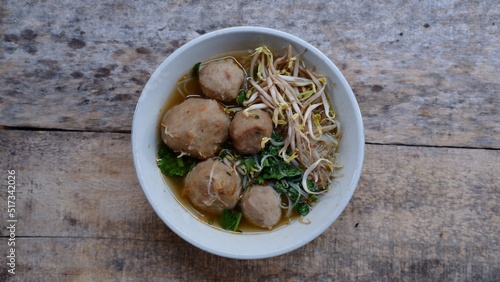 Bakso or Baso. Traditional Indonesian meatballs served with rice noodles Beans sprouts and green mustard. Indonesian street food called Bakso  photo