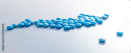 blue pills on white background. Sport doping, erection, concept