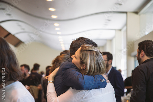 business couple hug each other at a conference
