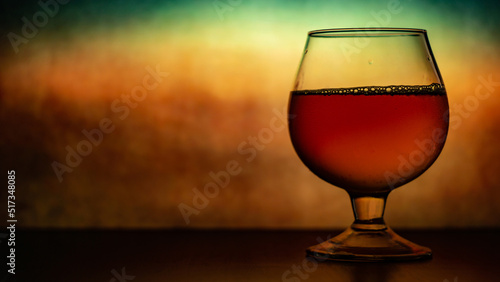 a glass with a cognak on theold vintage background  photo