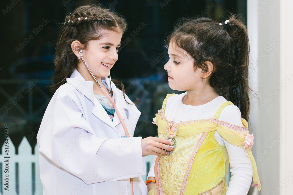 Little girls playing in kindergarten. Performance of two kids, doctor with her patient