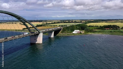 Flug über die Meerenge bei Insel Fehmarn, Fehmarnsund Brücke, fließender Verkehr, LKW, PKW, Bahn, Weiter Blick über die Insel, Ostsee, Schleswig-Holstein, Deutschland photo