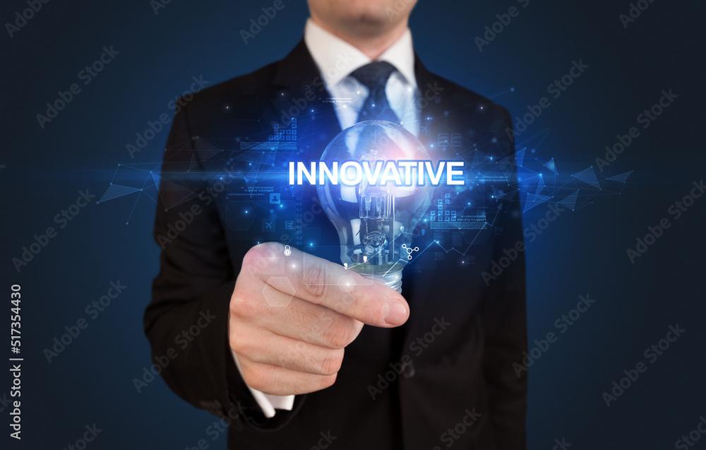 Fototapeta premium Businessman holding a light bulb