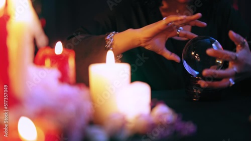 Experienced witch performing ritual over crystal ball, channeling spirits, magic