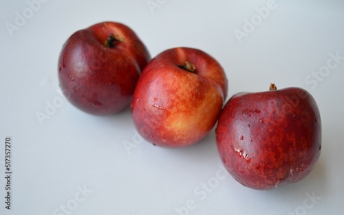 Fresh organic nectarines on a white background photo