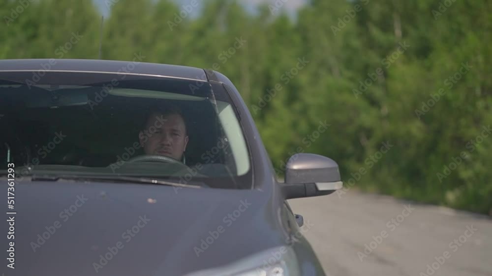 a man in a gray car drove up to an intersection a man in a gray car drove up to an intersection