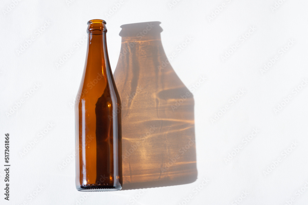 Empty beer bottle with shadow and light effect Empty beer bottle with shadow and light effect