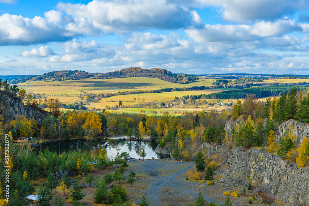 flooded quarry with trees around in autumn flooded quarry with trees around in autumn