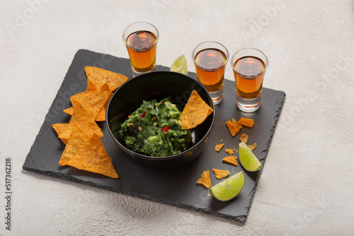 Latinamerican Mexican food party sauce guacamole, salsa, chips, and t equila. Nachos - A classic Mexican appetizer photo