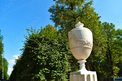 stone statue against the background of green trees