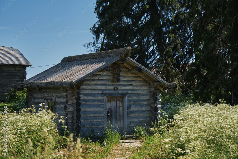 One of the most beautiful villages of Karelia Kinerma in summer. The old wooden house has been well preserved to our time. A small barn or storage. The concept of travel in Russia.