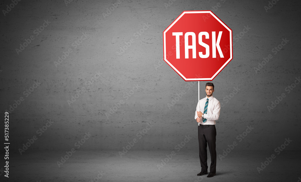 Obraz premium Young business person holding road sign