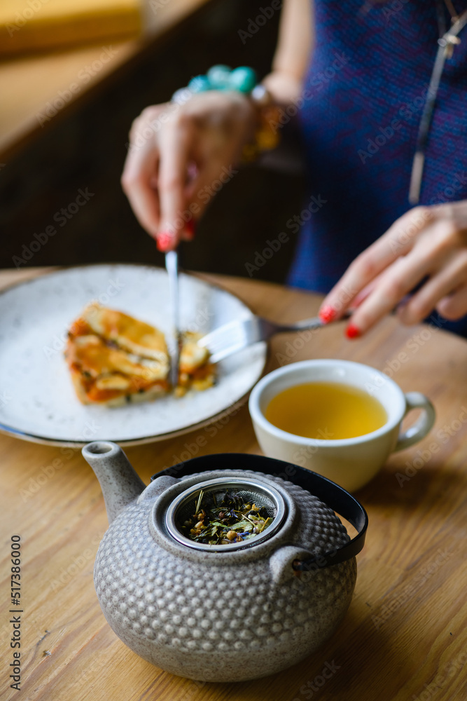 Close-up of a teapot with herbal tea in a coffee shop. Close-up of a teapot with herbal tea in a coffee shop.