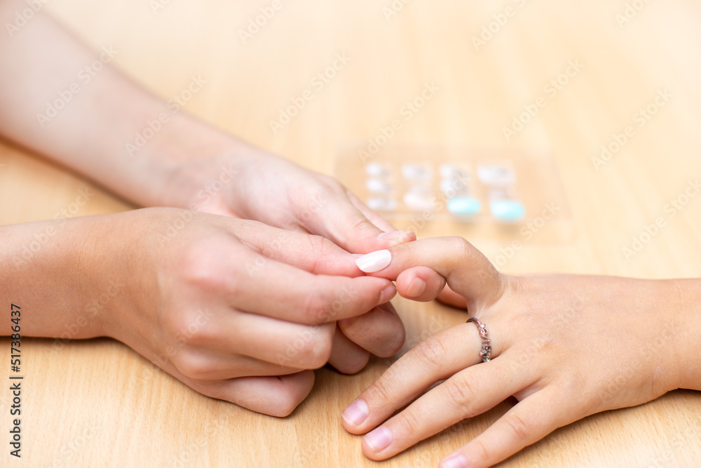 The girl sticks a toy nail. Children's toy manicure. The girl sticks a toy nail. Children's toy manicure.