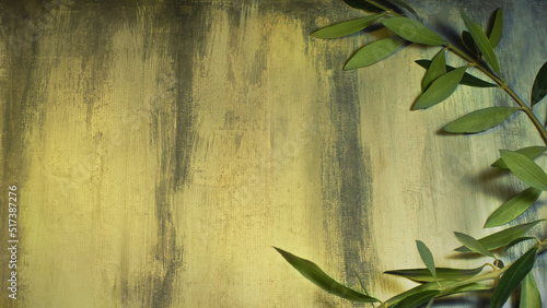 Olive branch on a grunge custom painted background. Symbol of peace and victory associated with customs of ancient Greece