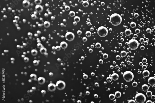 Dark oil with bubbles. Bubbles in liquid. Black and white. Oil concept. Oil business concept and petrol production