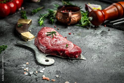 Pieces of cooked rump steak with spices served on old meat butcher. Steak of marbled beef black Angus. Raw beef ramp steak, top view photo