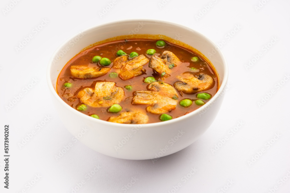 Mushroom and Pea Curry with Roasted Garlic, Indian food served in a bowl Mushroom and Pea Curry with Roasted Garlic, Indian food served in a bowl