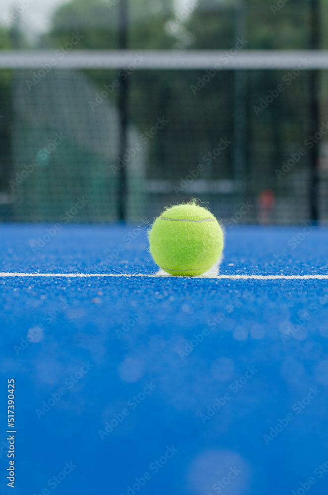 selective focus, ball on a paddle tennis court foreground and background out of focus