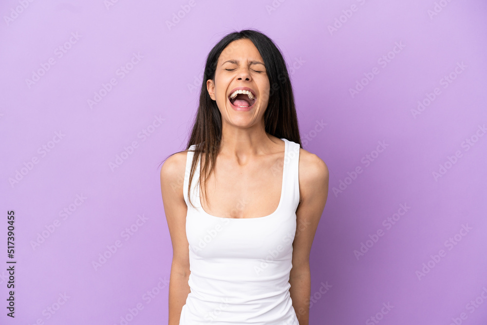 Young caucasian woman isolated on purple background shouting to the front with mouth wide open Young caucasian woman isolated on purple background shouting to the front with mouth wide open
