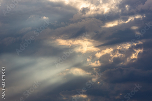 Beautiful monsoon skies above the Sonoran Desert, rays of light, sun beams shooting out from the clouds. Heaven like cloudscapes with dramatic colors and details in Tucson, Arizona, USA.
