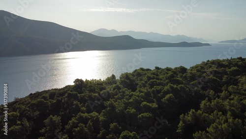 Sunrise in Croatia, reflections ona  bay between hills