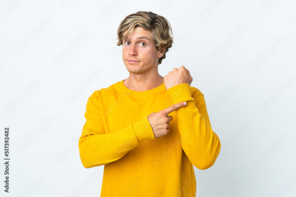 English man over isolated white background making the gesture of being late English man over isolated white background making the gesture of being late